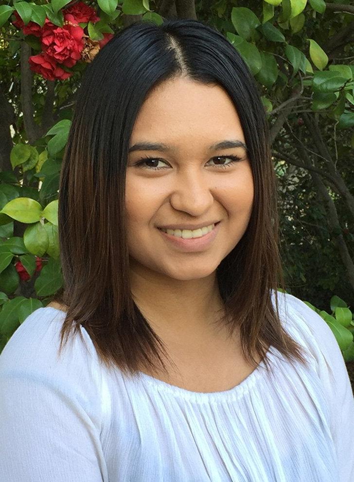 a portrait of Adriana Ceron wearing a white shirt